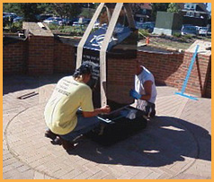 Workers setting the center monument of the police memorial